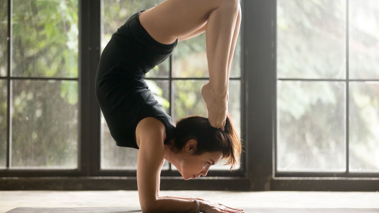 woman doing scorpion pose